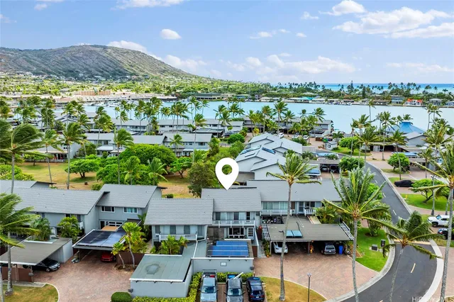 a view of multiple houses with outdoor space and a lake view