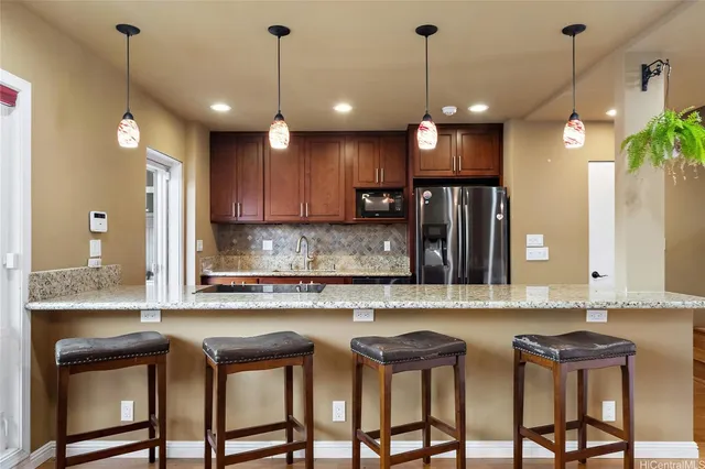 a kitchen with cabinets and chandelier