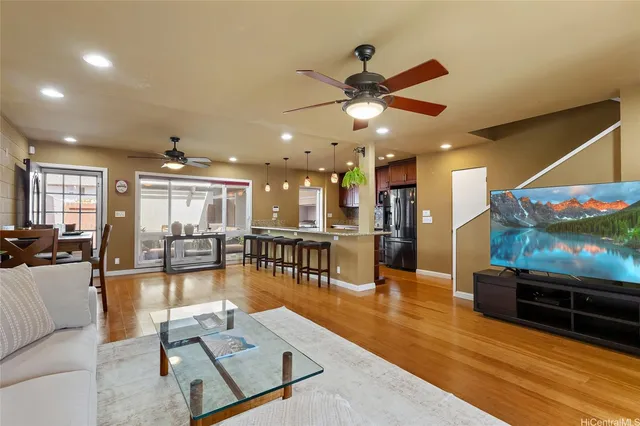 a living room with furniture and kitchen view