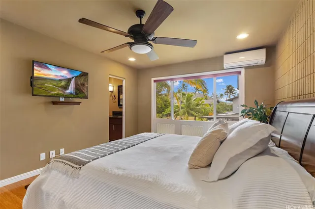 a bedroom with a bed and a flat screen tv
