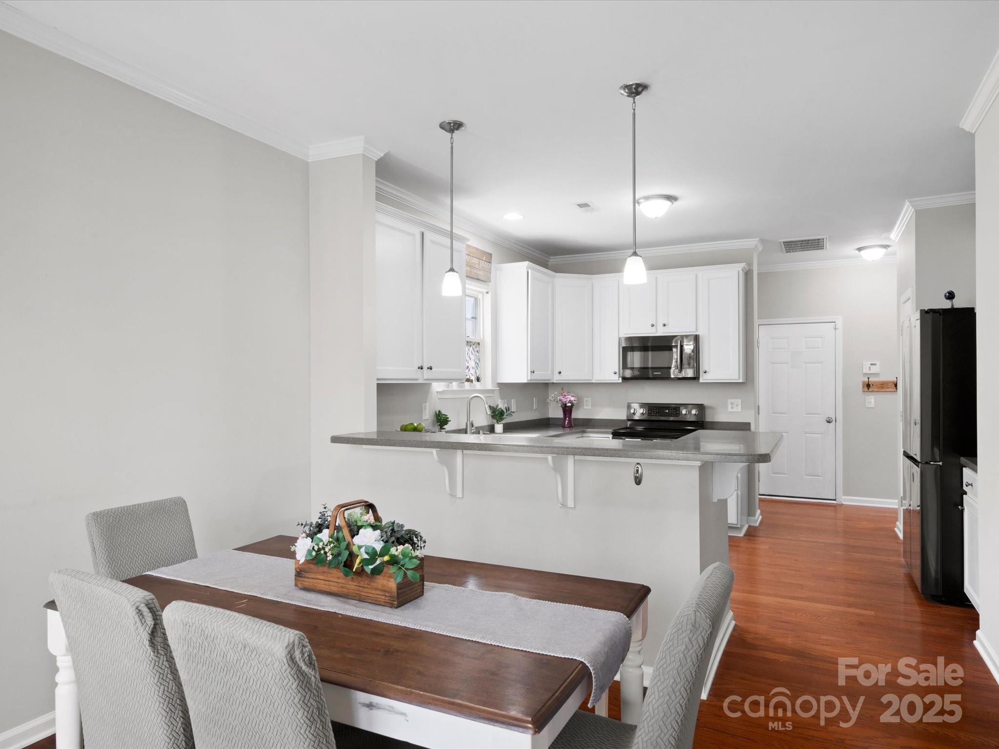 421 Silver Cypress Lane Fort Mill, SC 29708 - Photo 16 of 37 a kitchen with stainless steel appliances kitchen island granite countertop a sink and cabinets