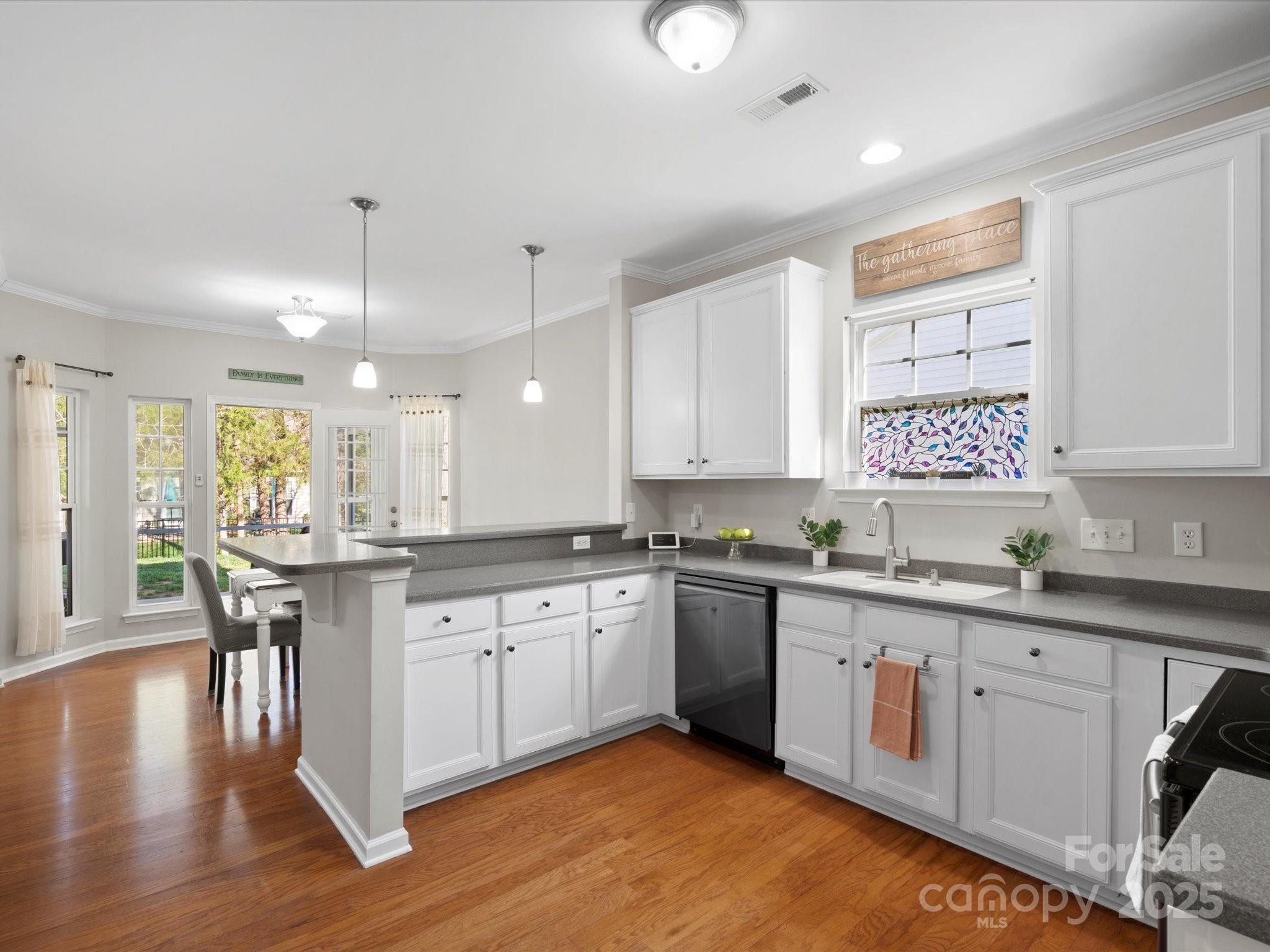 421 Silver Cypress Lane Fort Mill, SC 29708 - Photo 17 of 37 a kitchen with a sink cabinets and wooden floor