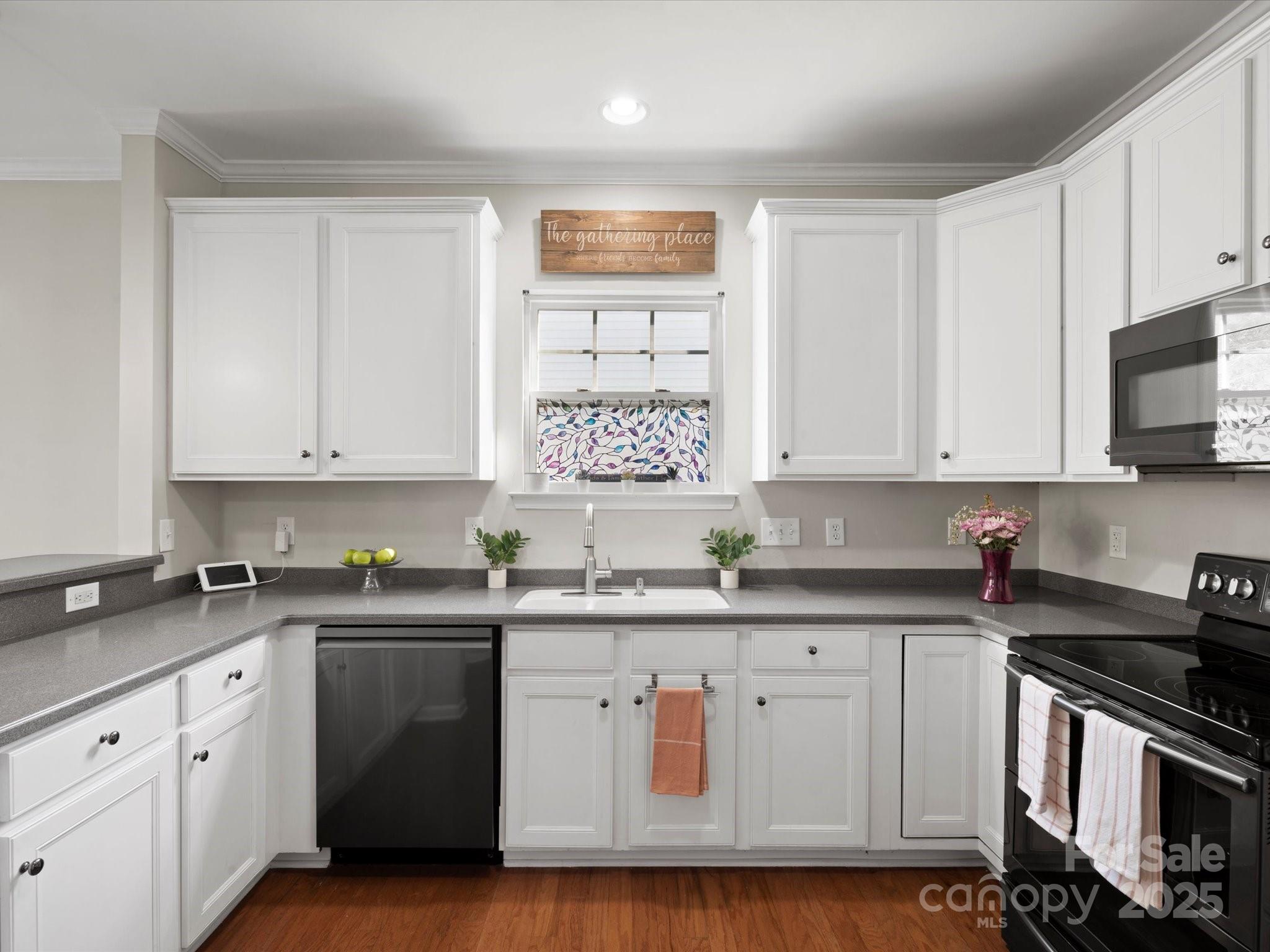 421 Silver Cypress Lane Fort Mill, SC 29708 - Photo 18 of 37 a kitchen with stainless steel appliances granite countertop a sink a stove a microwave and cabinets