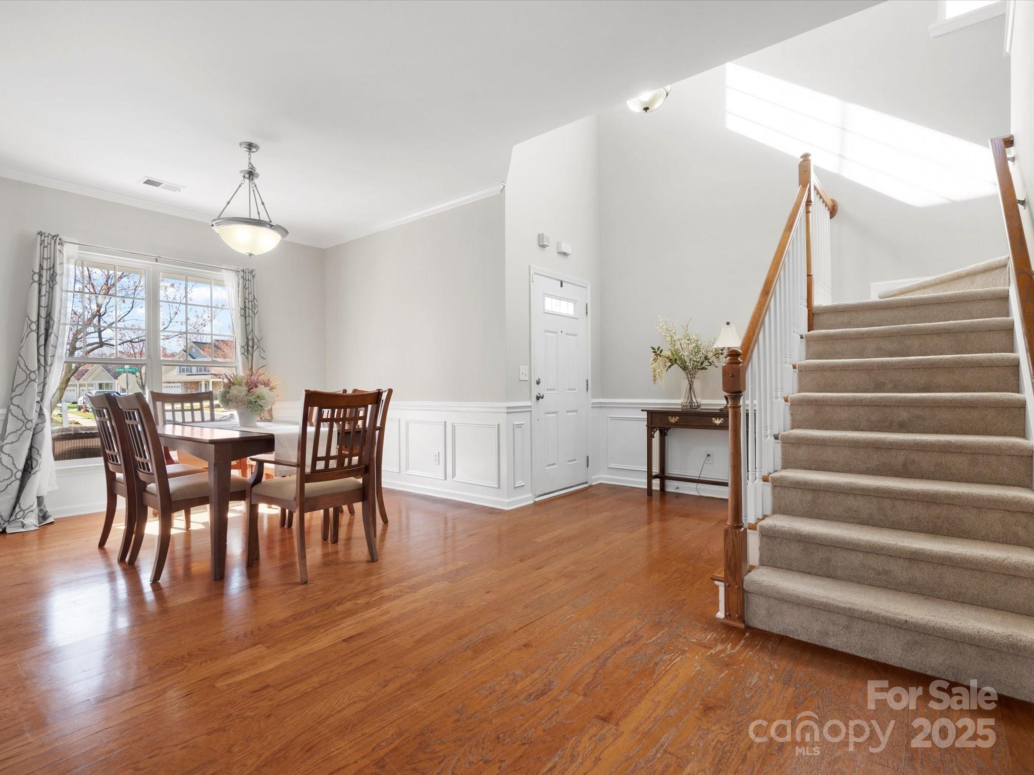 421 Silver Cypress Lane Fort Mill, SC 29708 - Photo 7 of 37 a view of a dining room with furniture and wooden floor