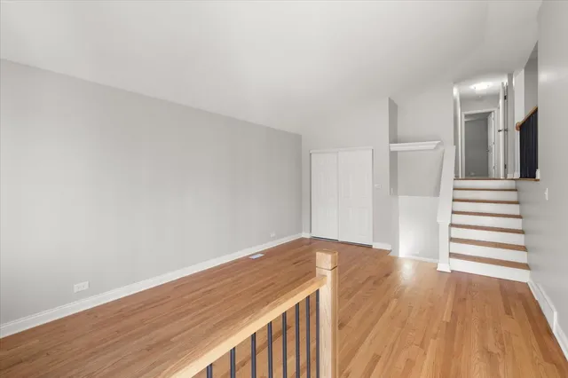 a view of a room with wooden floor and stairs