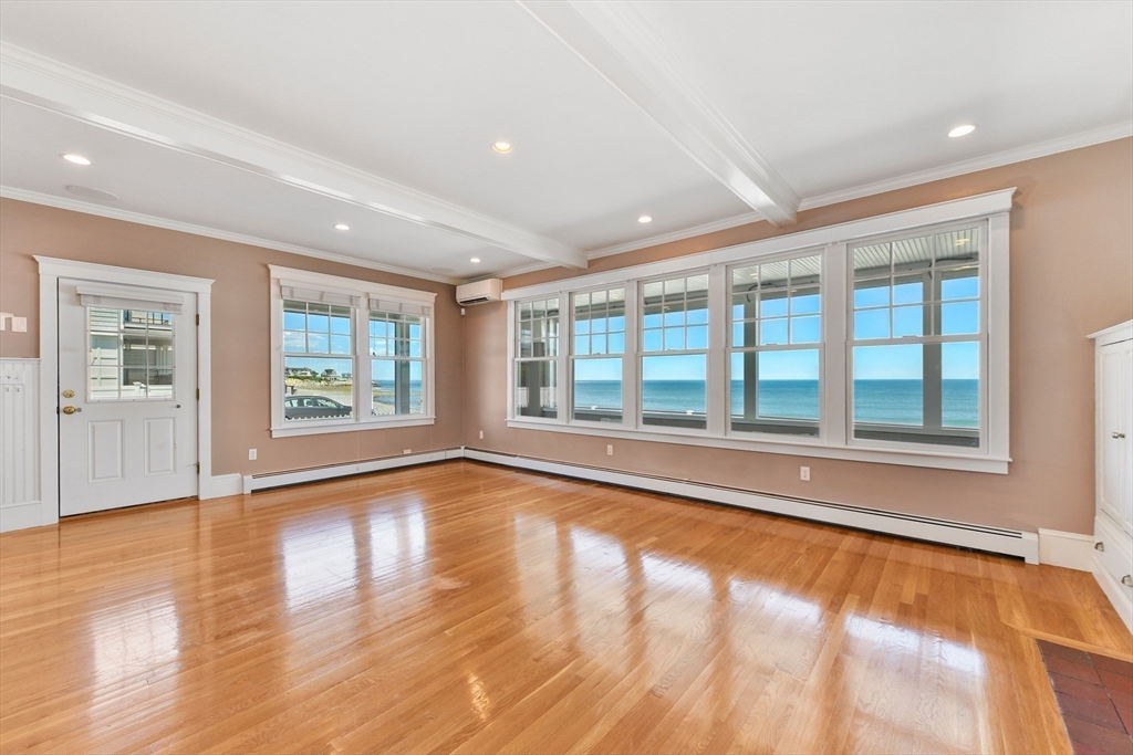 351 Beach Avenue Hull, MA 02045 - Photo 7 of 24 a view of an empty room with a window and wooden floor
