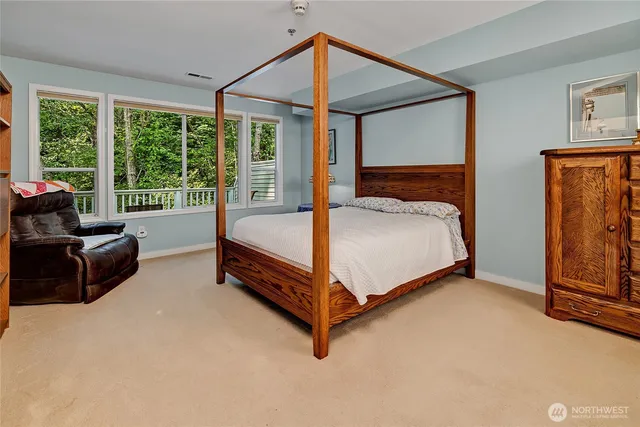 a bed sitting in a room next to a window