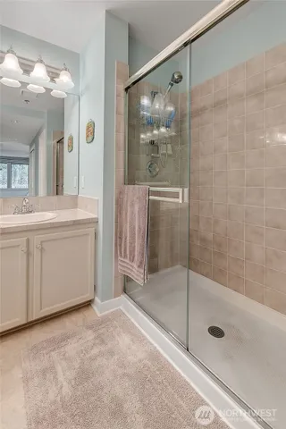 a bathroom with a shower and a sink