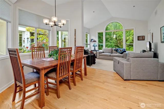 a view of a dining room with furniture large windows and wooden floor