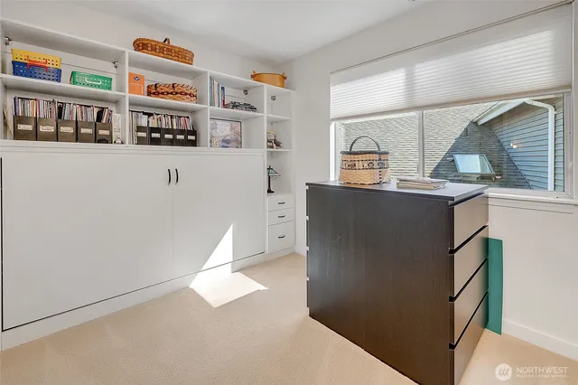 a view of a kitchen with fridge and window
