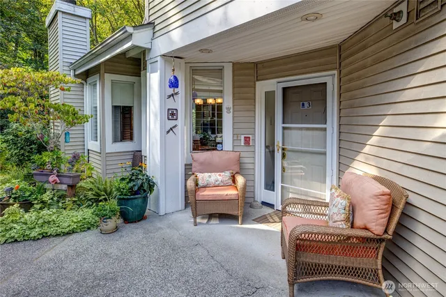 a view of a patio with a table and chairs and potted plants