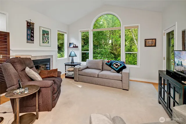 a living room with furniture a large window and a flat screen tv