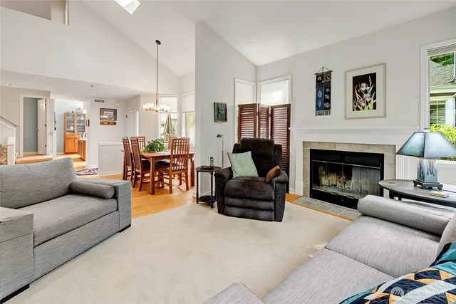 a living room with furniture fireplace and a window