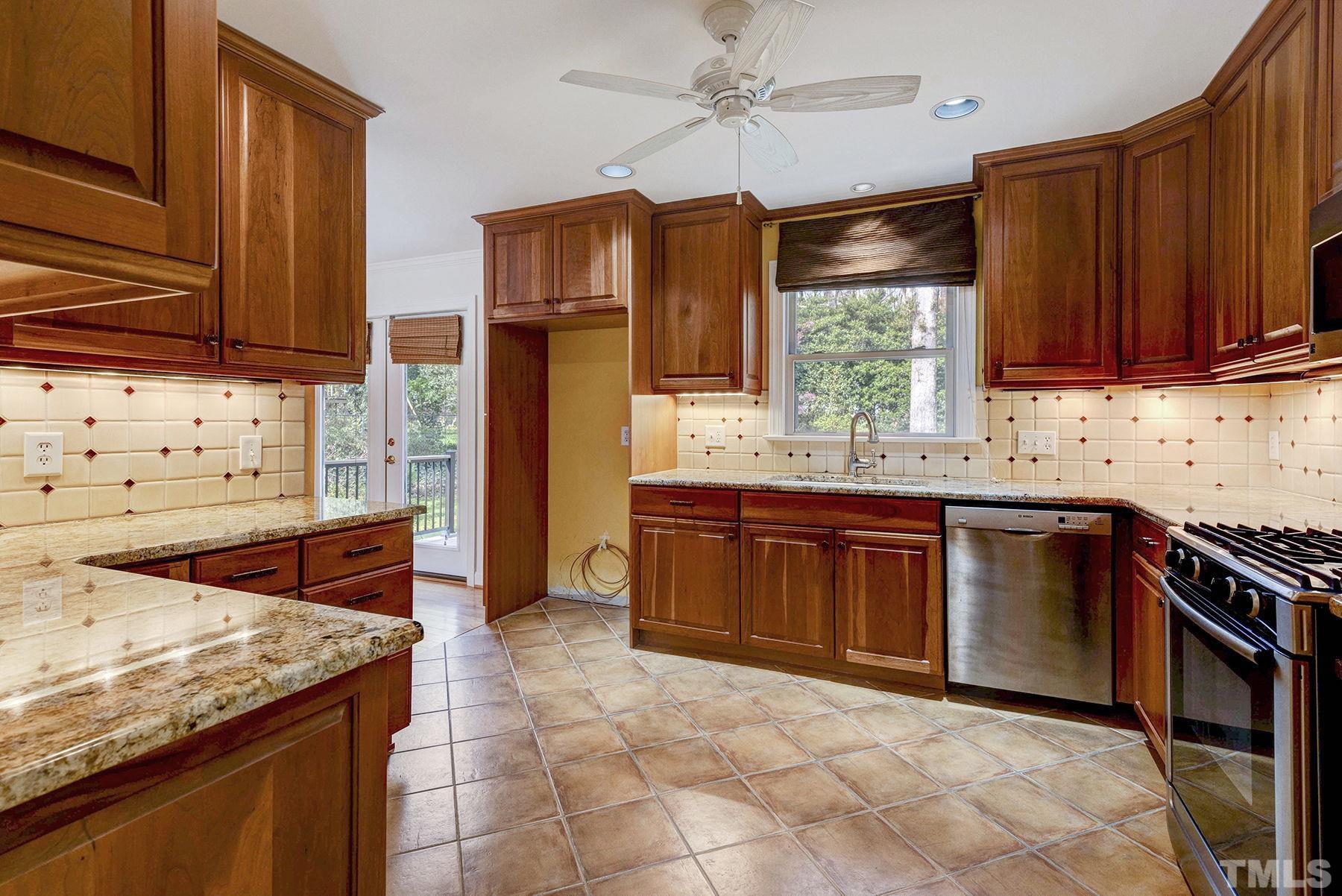 5505 Knollwood Road Raleigh, NC 27609 - Photo 11 of 33 a kitchen with stainless steel appliances granite countertop a stove a sink and a microwave