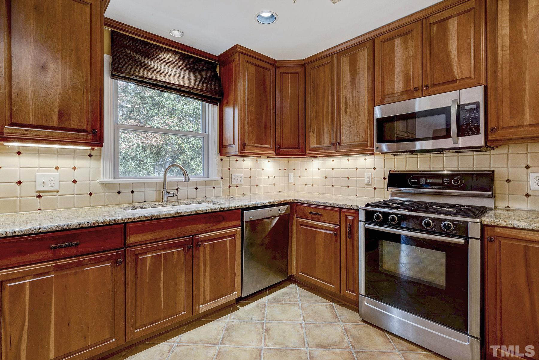 5505 Knollwood Road Raleigh, NC 27609 - Photo 12 of 33 a kitchen with stainless steel appliances granite countertop a sink stove and microwave