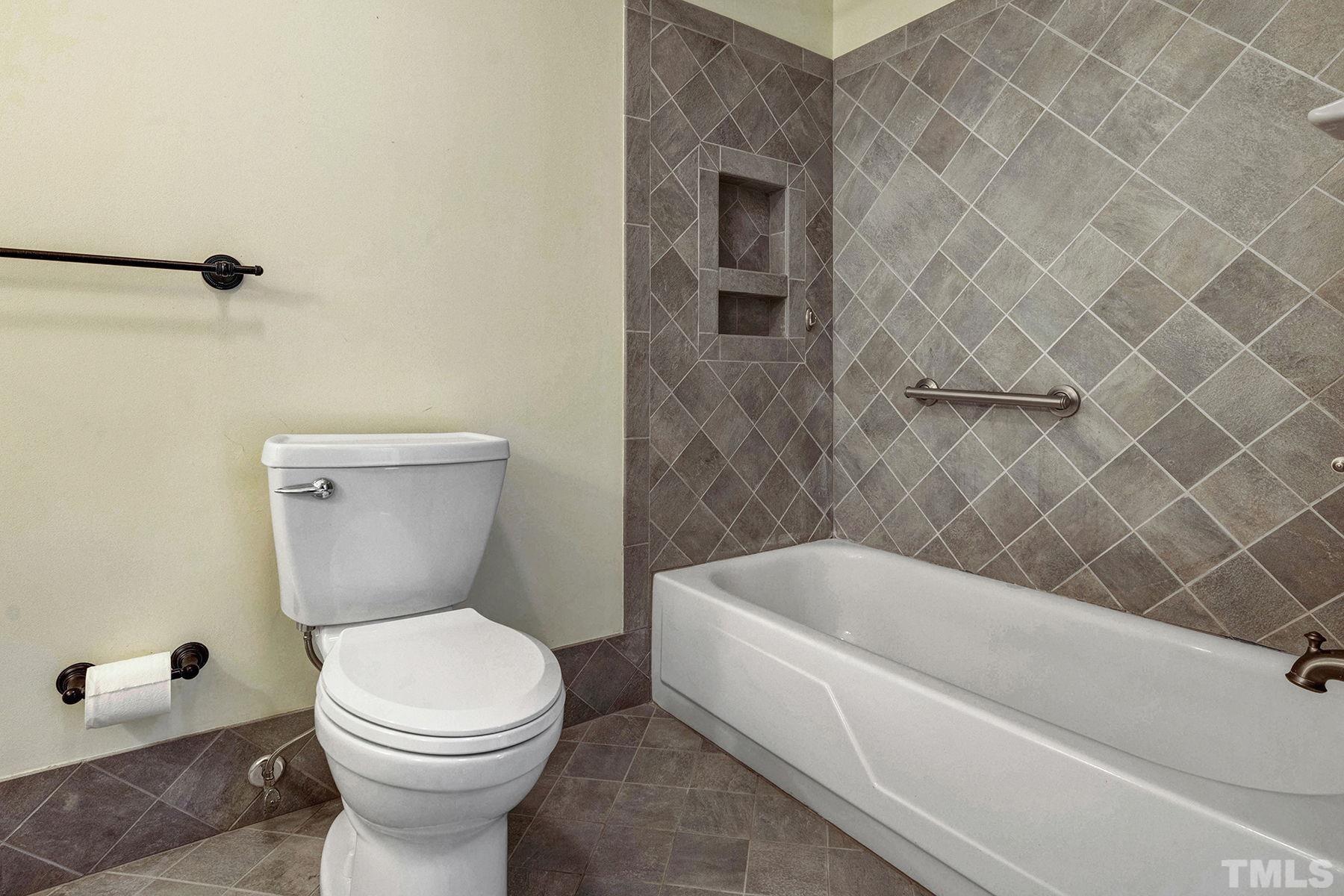 5505 Knollwood Road Raleigh, NC 27609 - Photo 15 of 33 a bathroom with a toilet a sink and bathtub