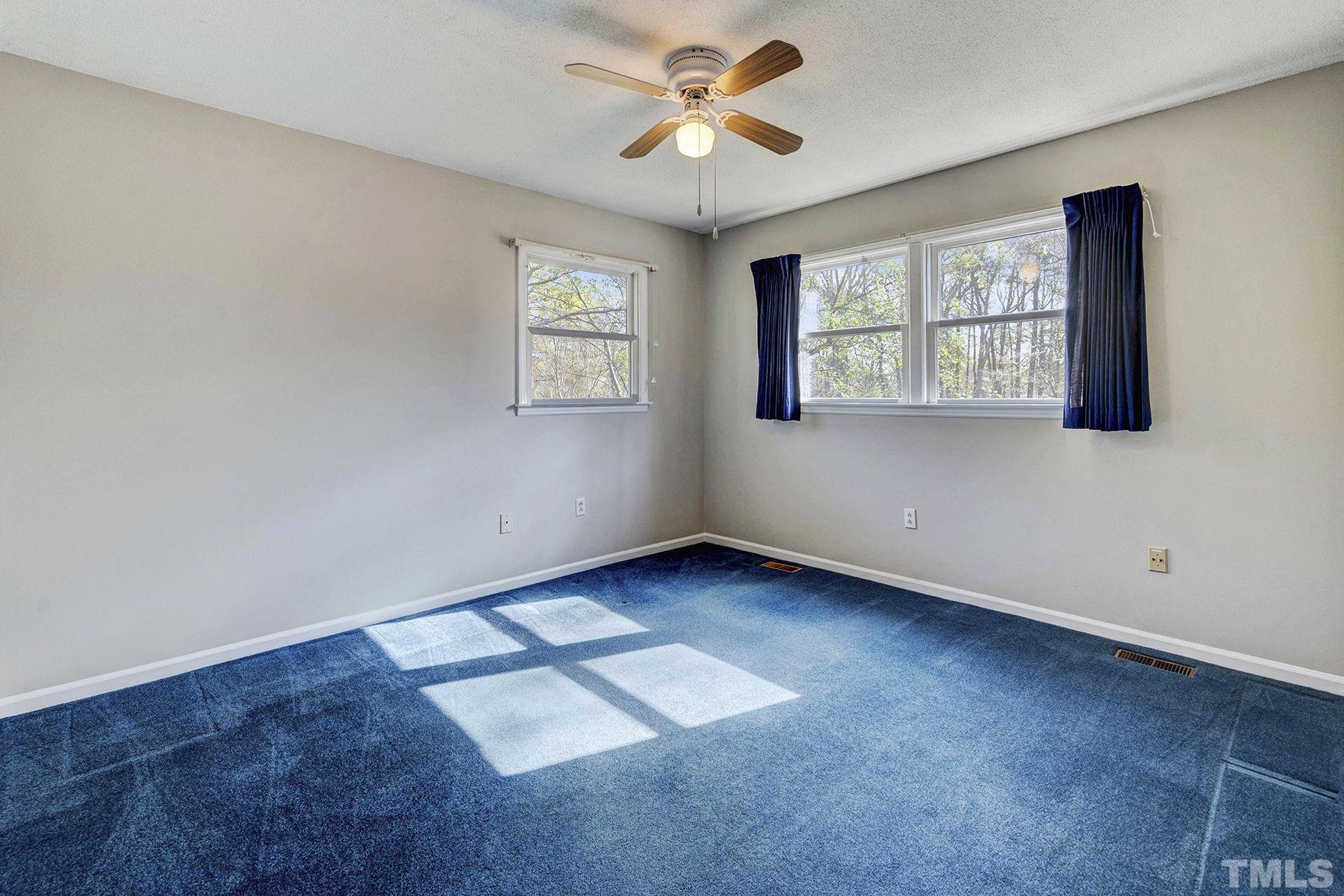 5505 Knollwood Road Raleigh, NC 27609 - Photo 17 of 33 an empty room with windows and fan