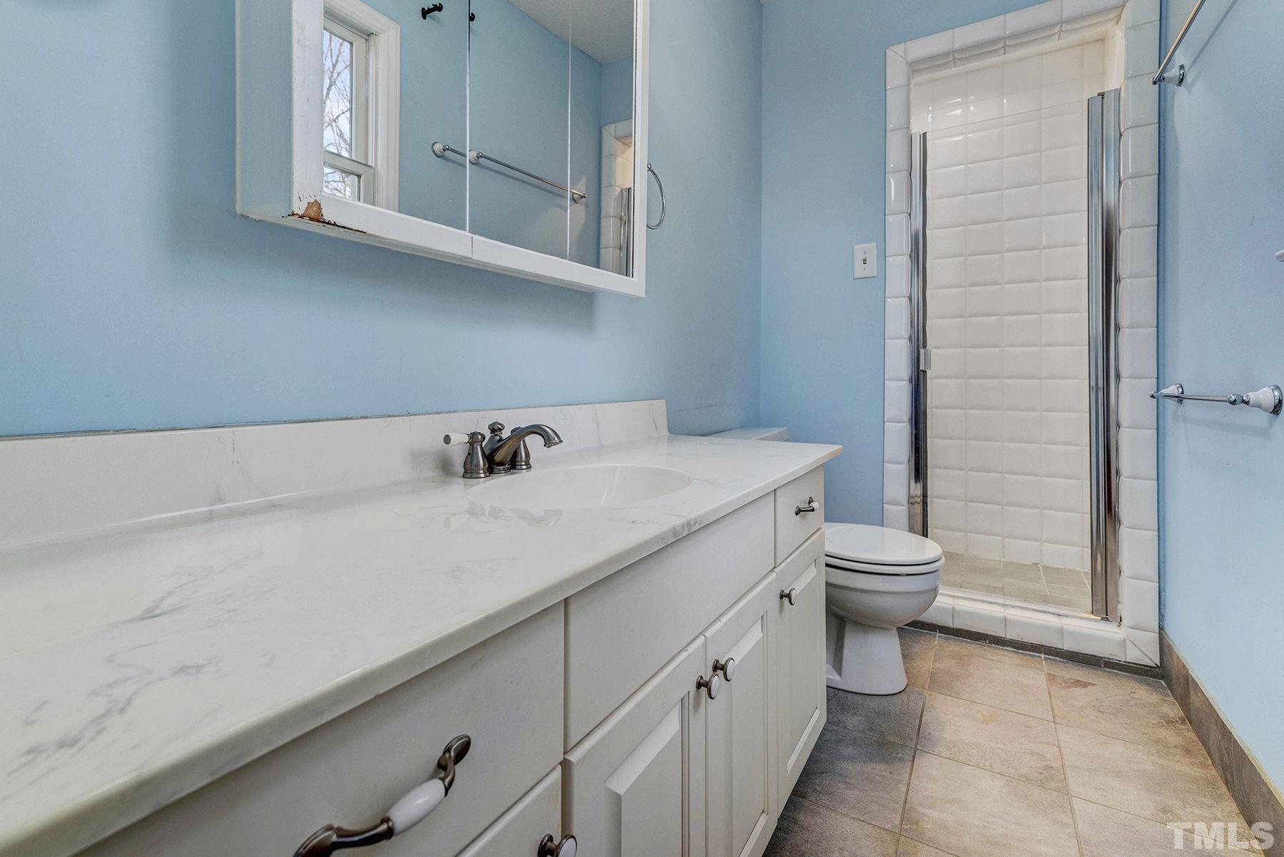 5505 Knollwood Road Raleigh, NC 27609 - Photo 19 of 33 a bathroom with a sink and a toilet