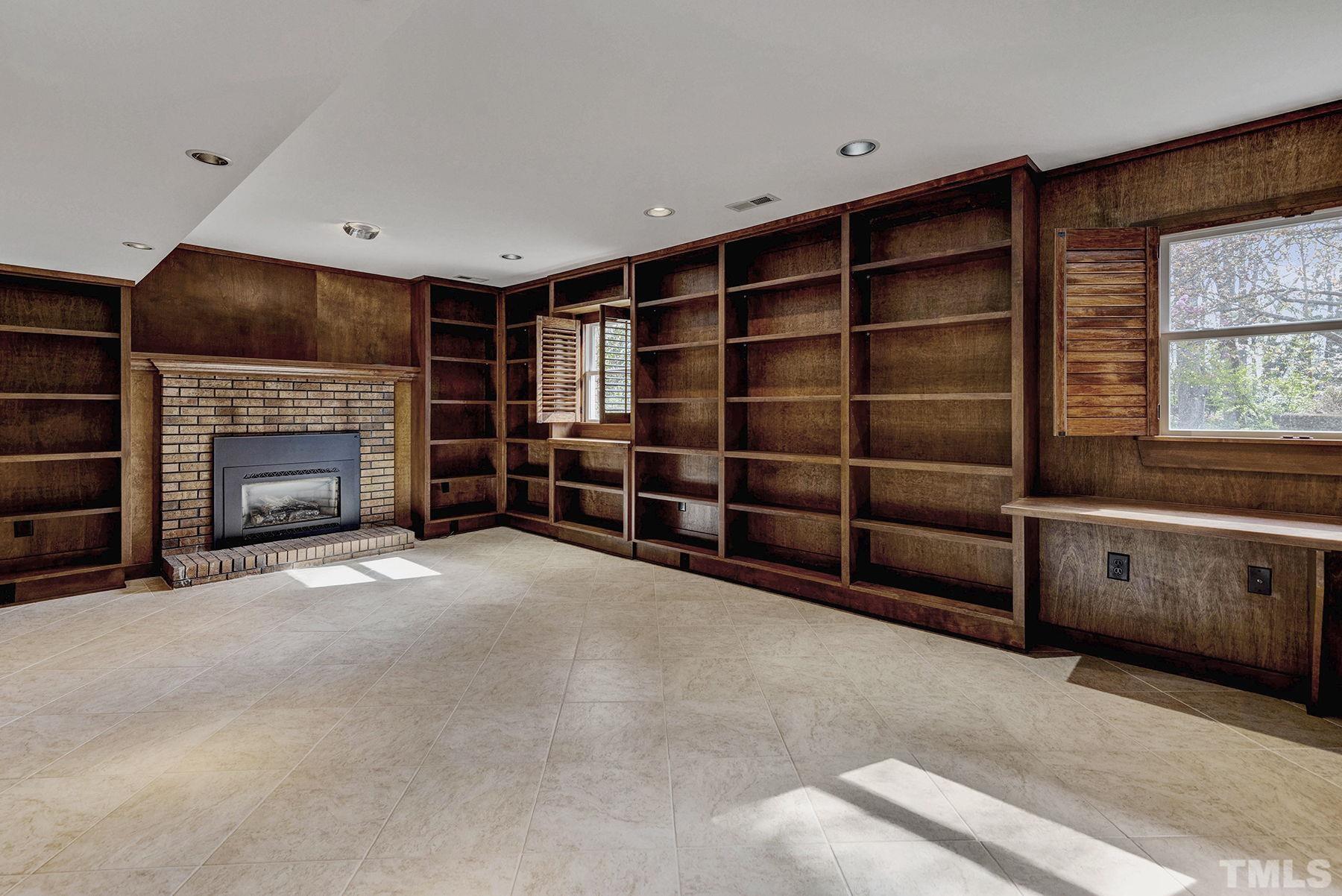 5505 Knollwood Road Raleigh, NC 27609 - Photo 20 of 33 a view of an empty room with a fireplace and window