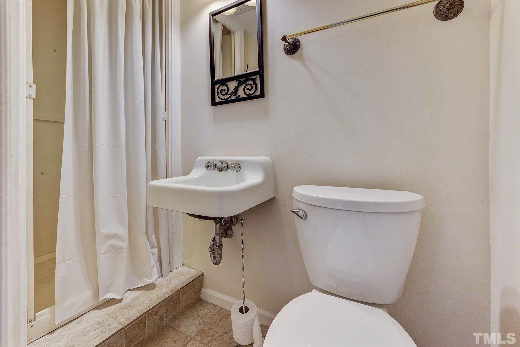 5505 Knollwood Road Raleigh, NC 27609 - Photo 25 of 33 a white toilet sitting next to a bathroom sink