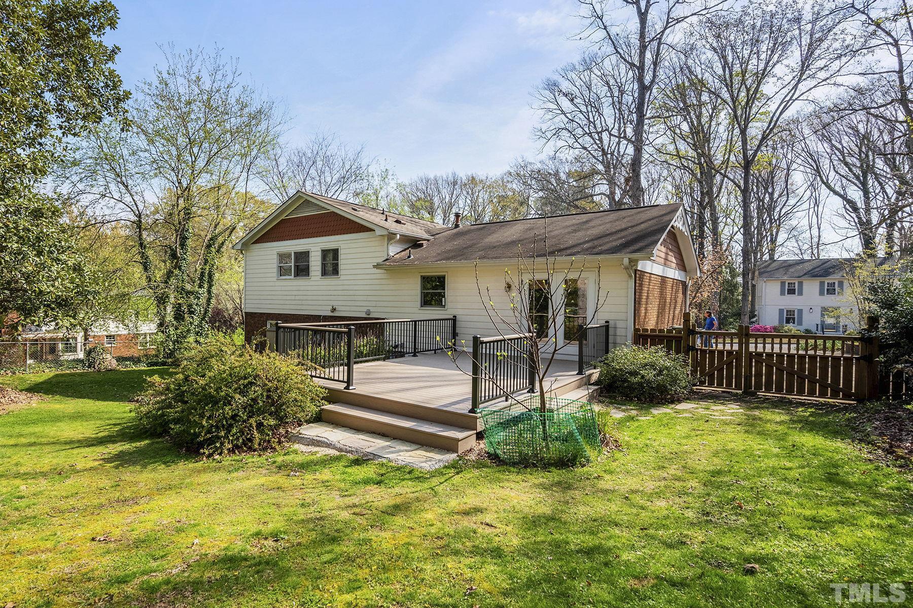 5505 Knollwood Road Raleigh, NC 27609 - Photo 28 of 33 a front view of a house with a yard table and chairs