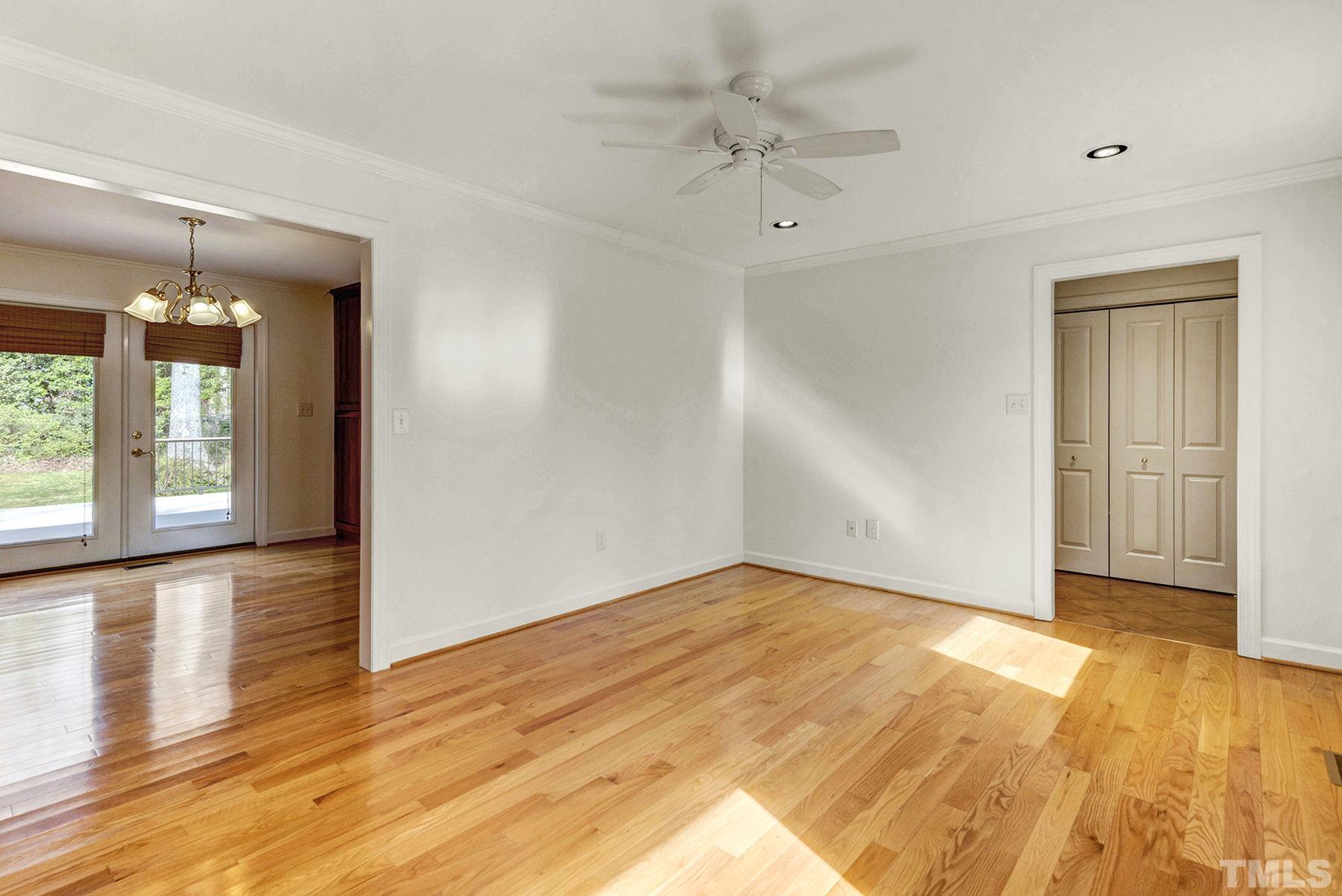 5505 Knollwood Road Raleigh, NC 27609 - Photo 5 of 33 a view of an empty room with wooden floor and a window
