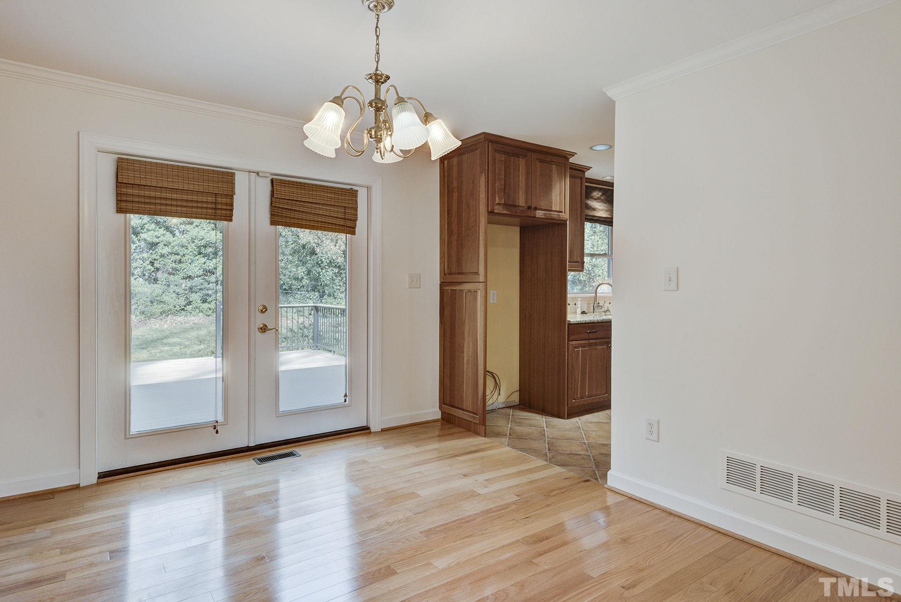 5505 Knollwood Road Raleigh, NC 27609 - Photo 7 of 33 a view of a room with wooden floor and large windows