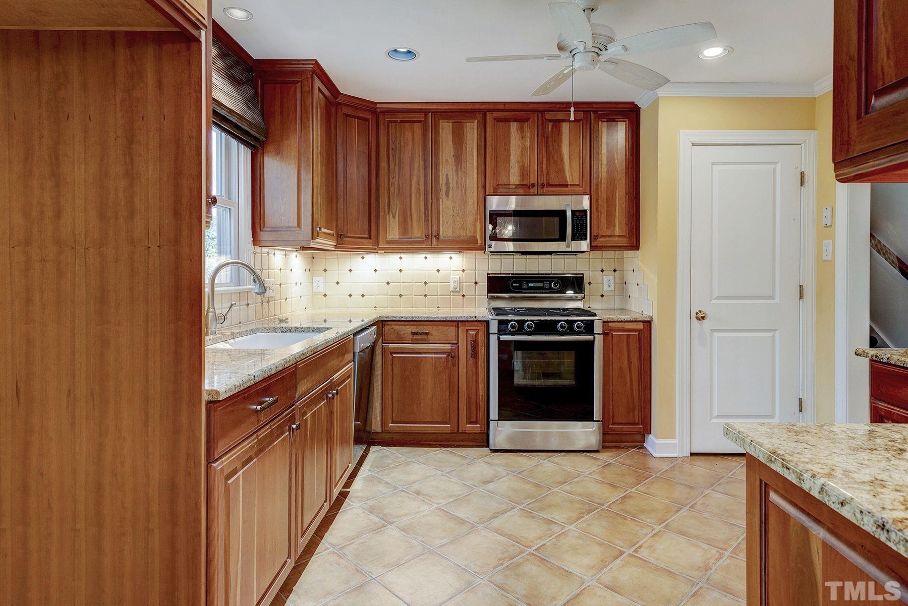 5505 Knollwood Road Raleigh, NC 27609 - Photo 8 of 33 a kitchen with stainless steel appliances granite countertop a stove top oven a sink and dishwasher
