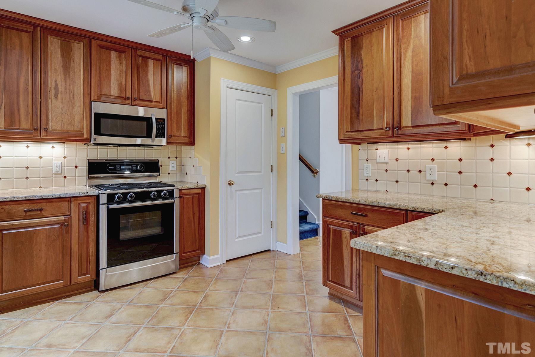 5505 Knollwood Road Raleigh, NC 27609 - Photo 9 of 33 a kitchen with stainless steel appliances granite countertop a stove microwave and cabinets