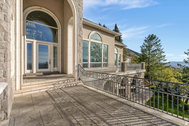 3222 Eagle View Circle Sandy, UT 84092 - Photo 4 of 60 Entrance to property featuring stucco siding, a mountain view, and stone siding
