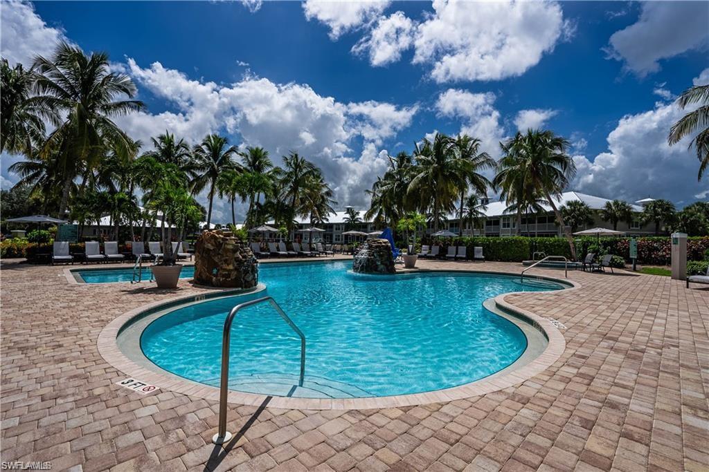 7935 Mahogany Run Lane, Unit 726 Naples, FL 34113 - Photo 21 of 24 Community pool featuring a patio