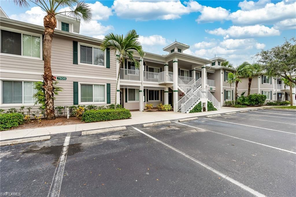 7935 Mahogany Run Lane, Unit 726 Naples, FL 34113 - Photo 23 of 24 View of apartment building / complex with stairway and uncovered parking