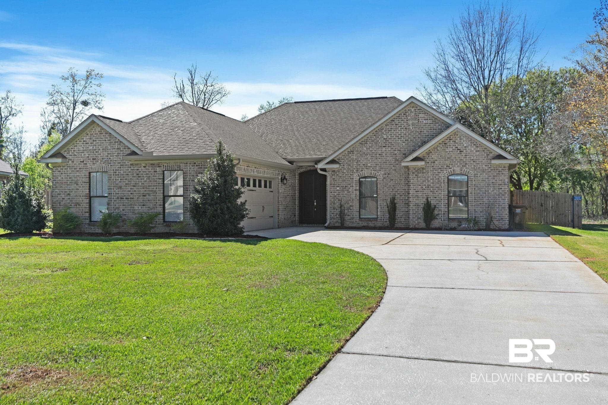 9584 Sanibel Loop Daphne, AL 36526 - Photo 1 of 48 View of front of house featuring concrete driveway, brick siding, a garage, and roof with shingles