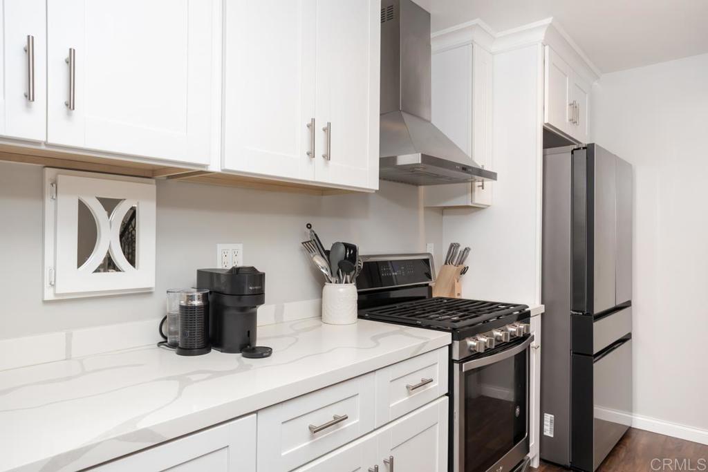 12151 Wintercrest Drive, Unit 3 Lakeside, CA 92040 - Photo 2 of 11 a kitchen with stainless steel appliances granite countertop a refrigerator and a stove