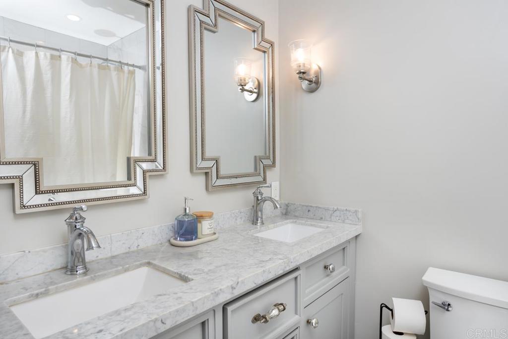 12151 Wintercrest Drive, Unit 3 Lakeside, CA 92040 - Photo 6 of 11 a bathroom with a granite countertop sink and a mirror