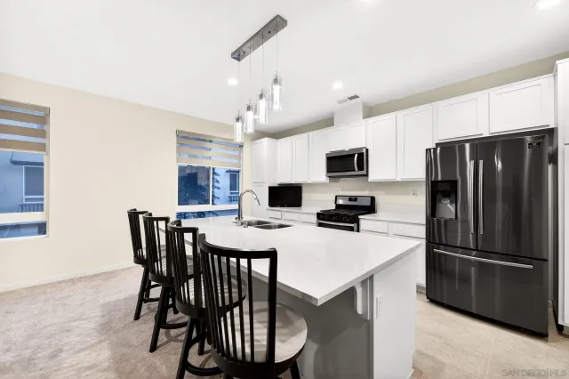 a kitchen with a dining table and chairs