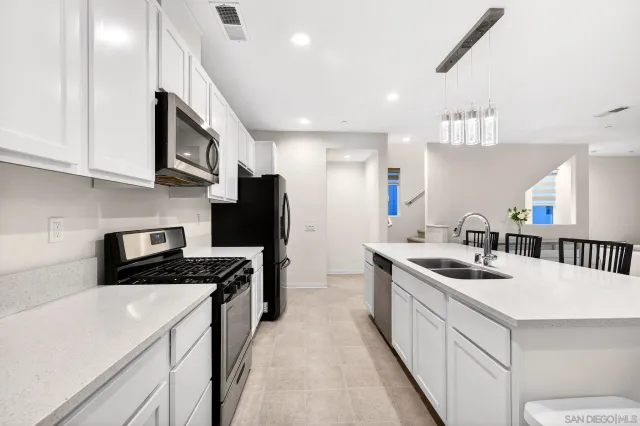 a kitchen that has a sink and a stove in it