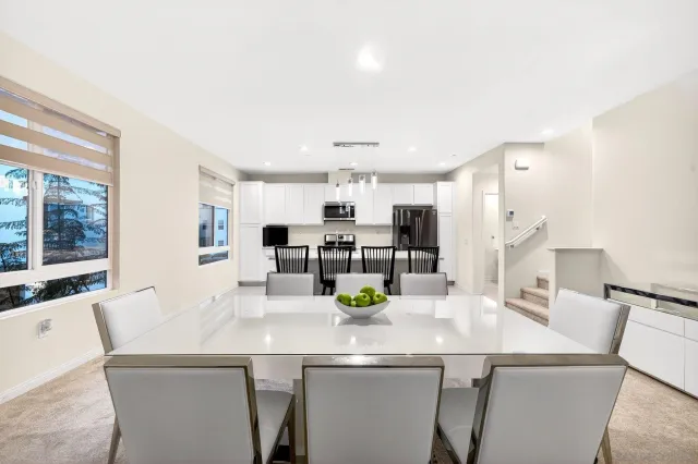 a kitchen with a sink and chairs
