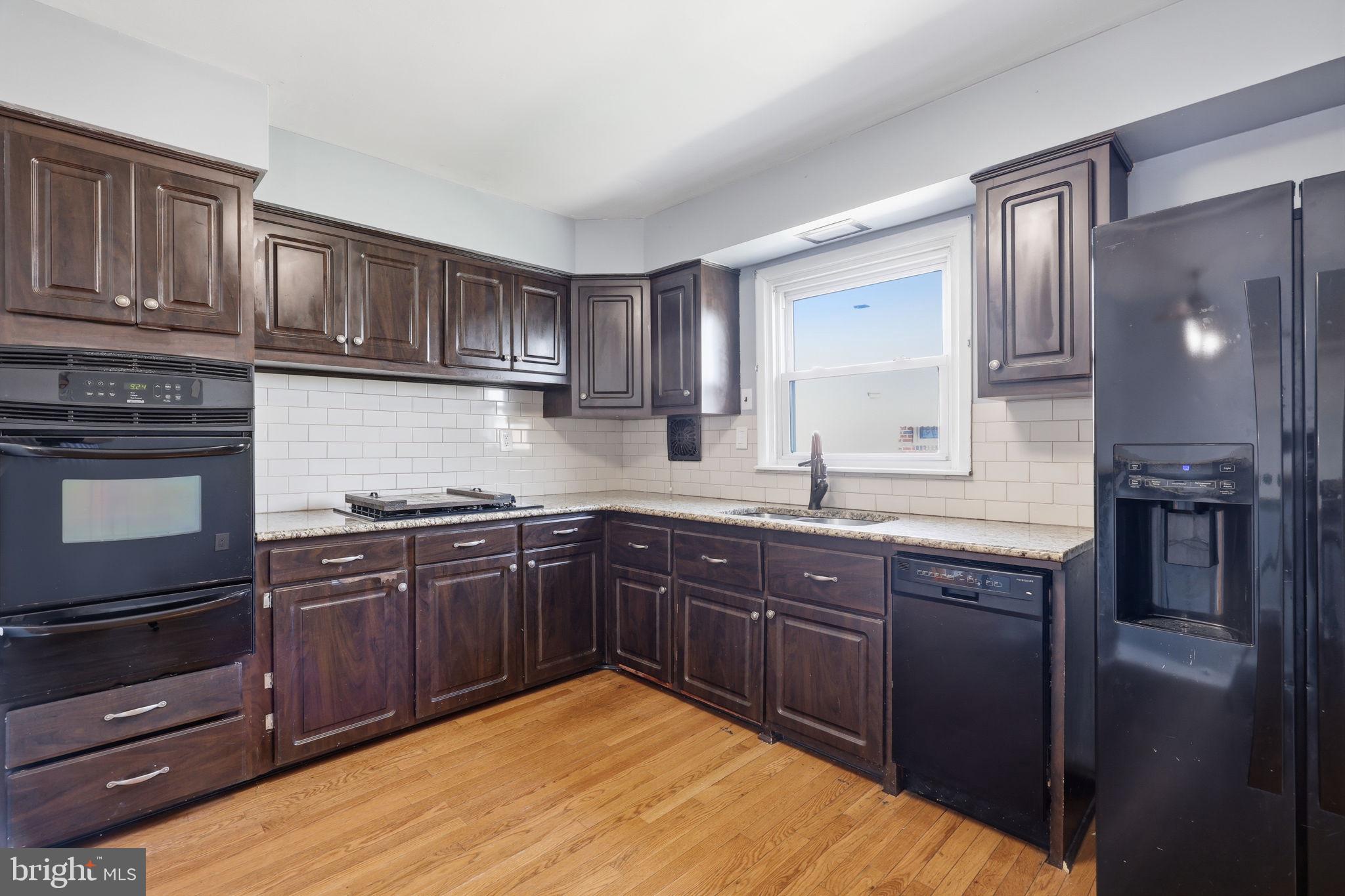 3908 Pearson Avenue Philadelphia, PA 19114 - Photo 12 of 30 a kitchen with stainless steel appliances granite countertop wooden cabinets a sink and dishwasher