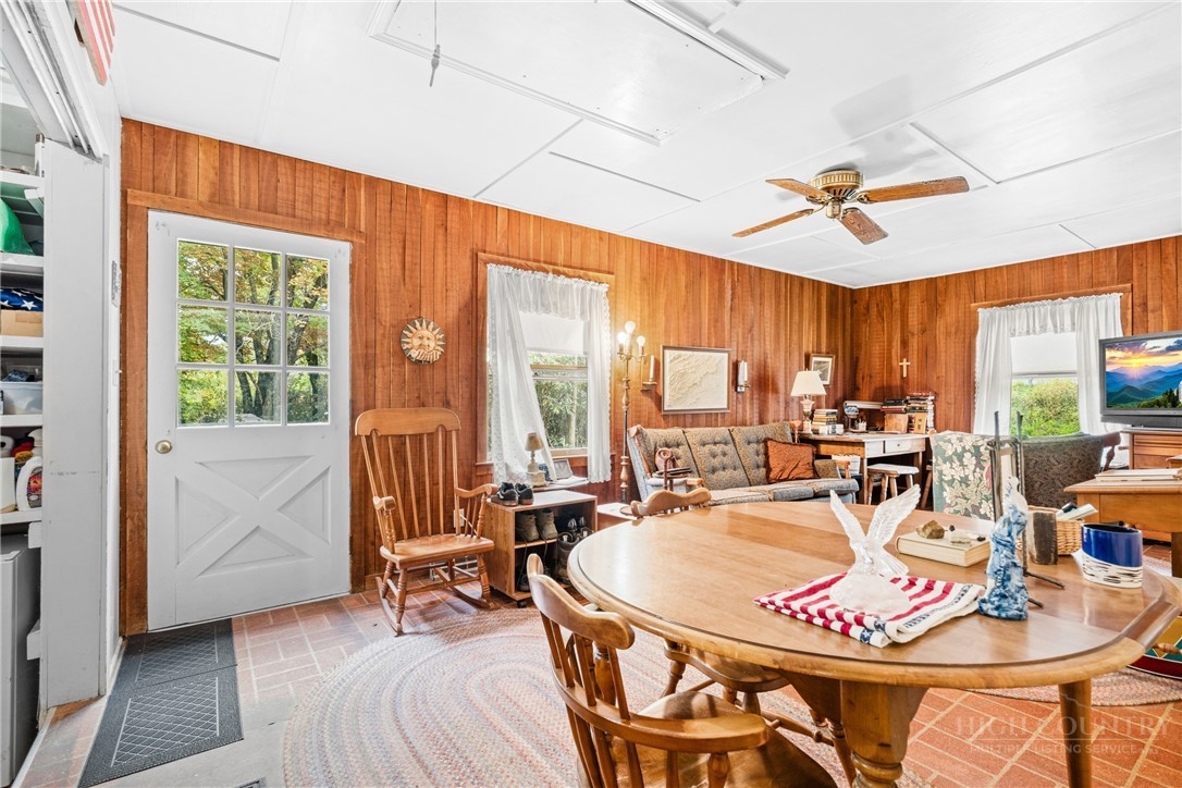 1794 Highway 105 Boone, NC 28607 - Photo 19 of 29 a dining room with furniture a chandelier and wooden floor
