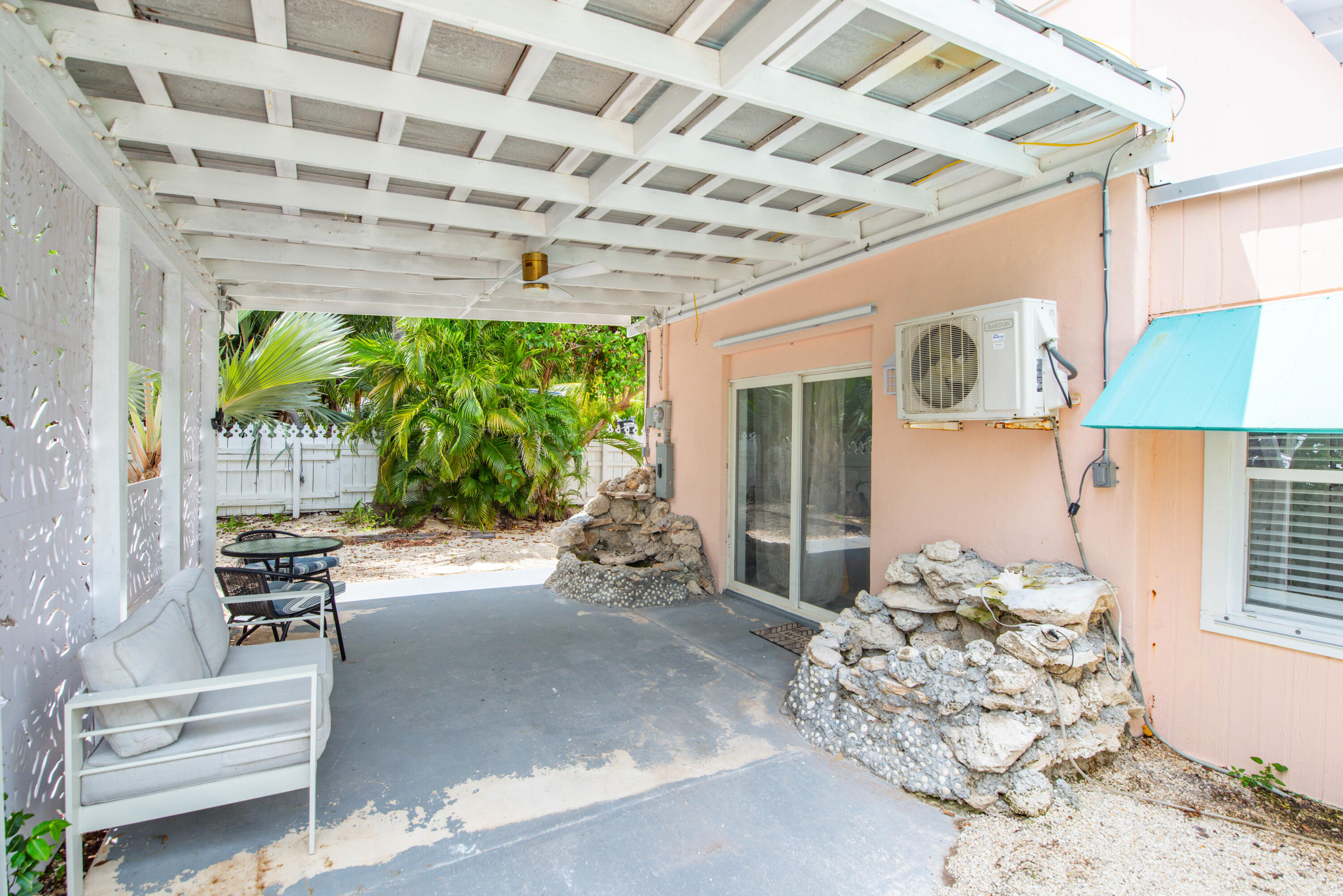 31541 Ave A Big Pine Key, FL 33043 - Photo 19 of 35 a view of a porch with furniture and a potted plant