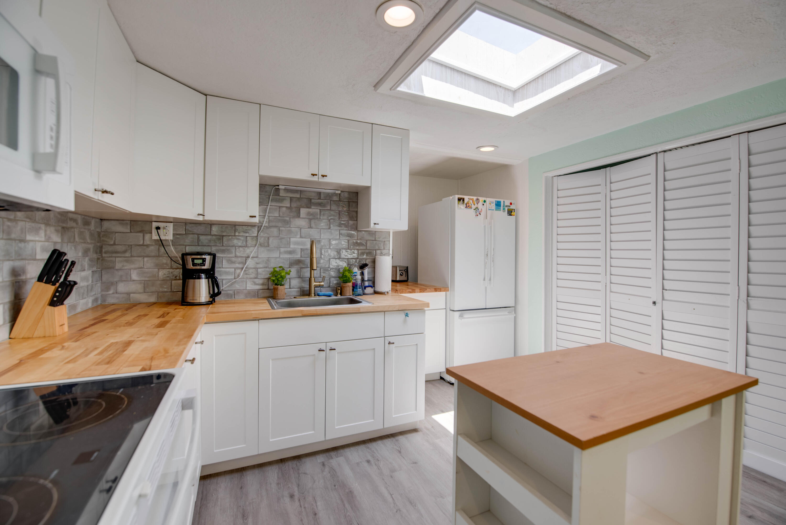31541 Ave A Big Pine Key, FL 33043 - Photo 4 of 35 a kitchen with stainless steel appliances granite countertop a sink a stove a refrigerator and cabinets