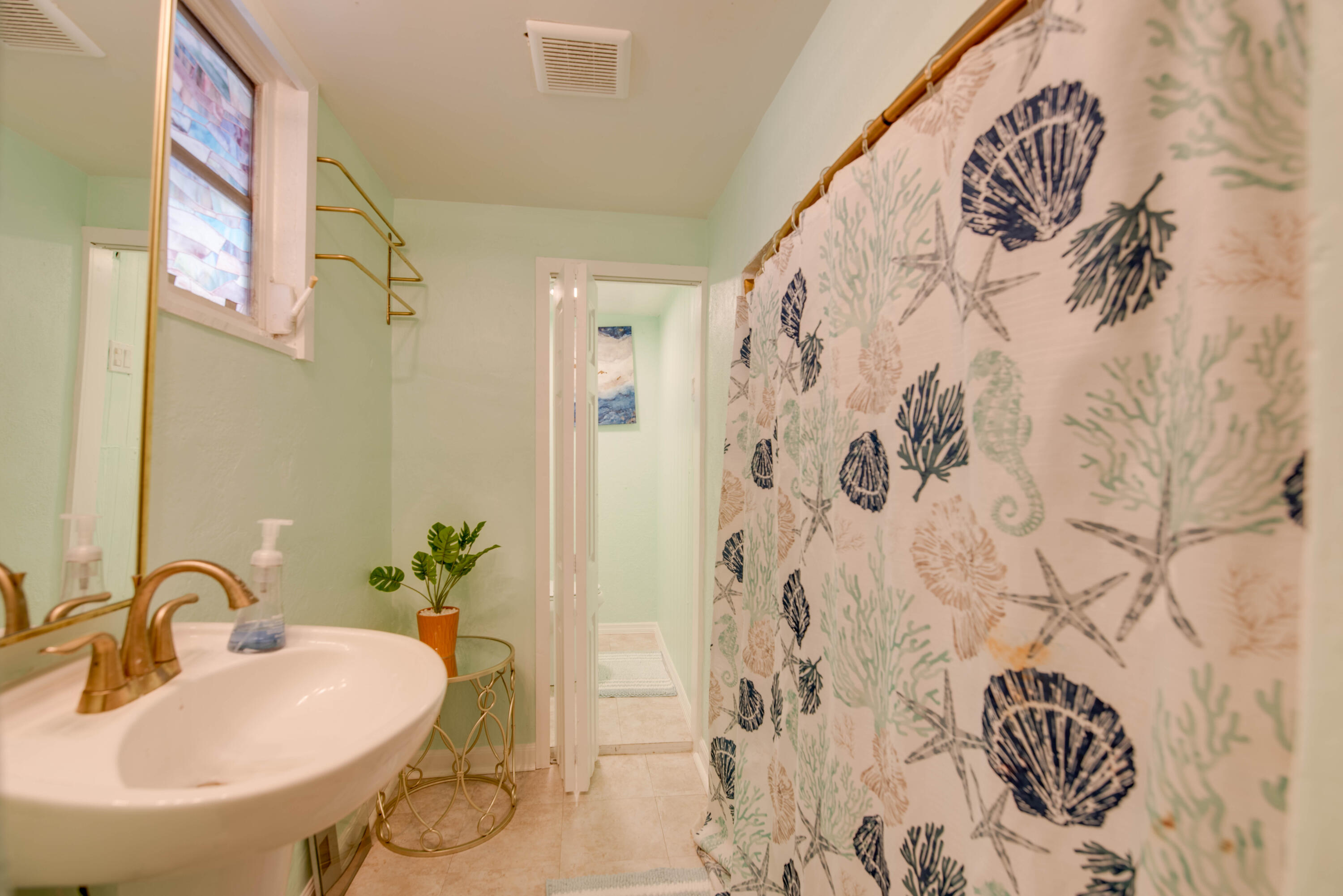 31541 Ave A Big Pine Key, FL 33043 - Photo 9 of 35 a bathroom with a sink and mirror with bathtub