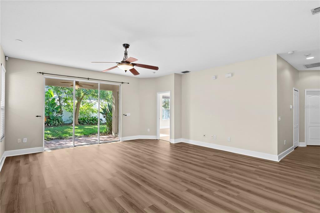 5012 Mirror Ridge Court Lutz, FL 33558 - Photo 14 of 44 a view of an empty room with wooden floor and a window