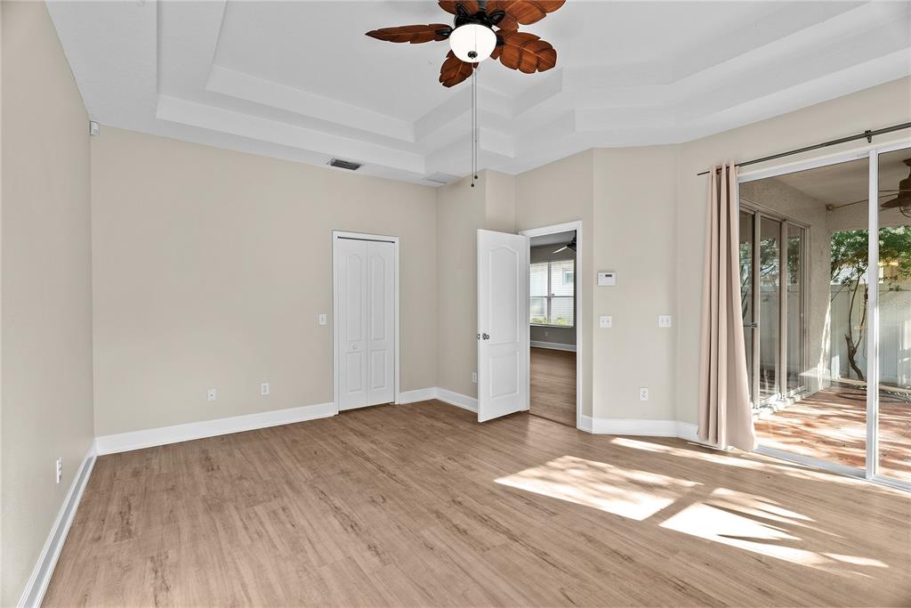 5012 Mirror Ridge Court Lutz, FL 33558 - Photo 20 of 44 a view of an empty room with wooden floor and a window