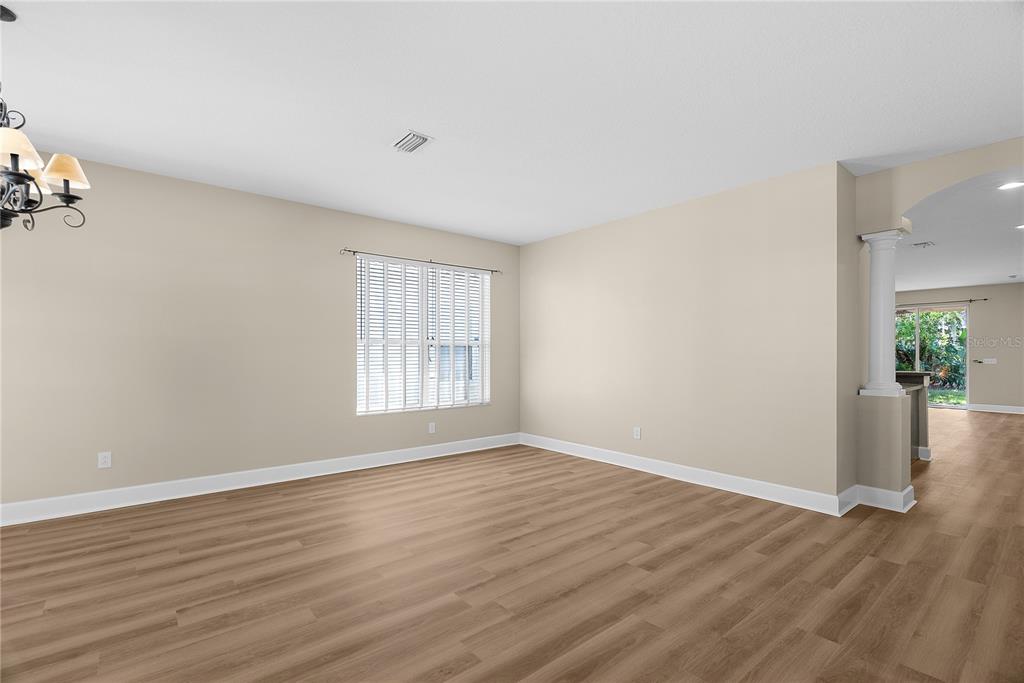 5012 Mirror Ridge Court Lutz, FL 33558 - Photo 32 of 44 an empty room with wooden floor and windows