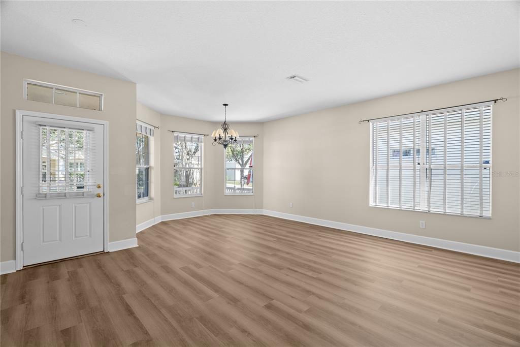 5012 Mirror Ridge Court Lutz, FL 33558 - Photo 33 of 44 an empty room with wooden floor and windows