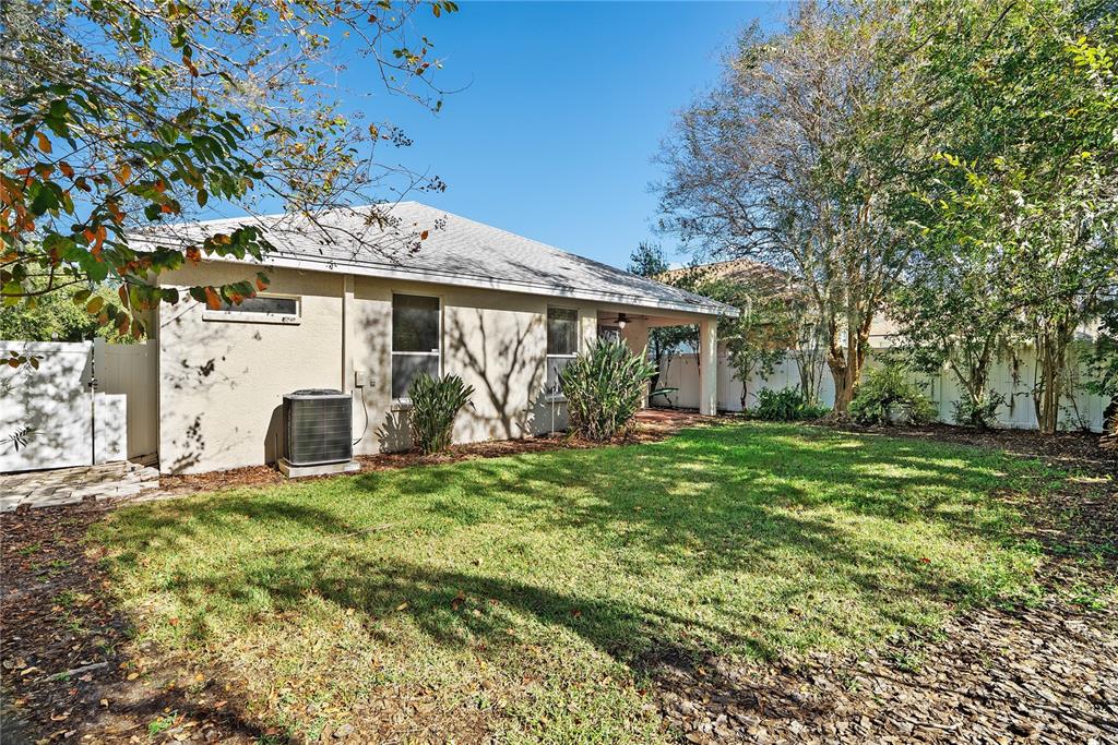 5012 Mirror Ridge Court Lutz, FL 33558 - Photo 42 of 44 a view of a house with a yard