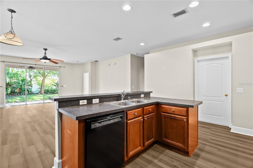 5012 Mirror Ridge Court Lutz, FL 33558 - Photo 9 of 44 a kitchen with stainless steel appliances granite countertop a sink stove and wooden floor