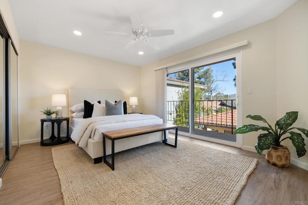 3163 Via De Caballo Encinitas, CA 92024 - Photo 18 of 23 a spacious bedroom with a bed and large windows